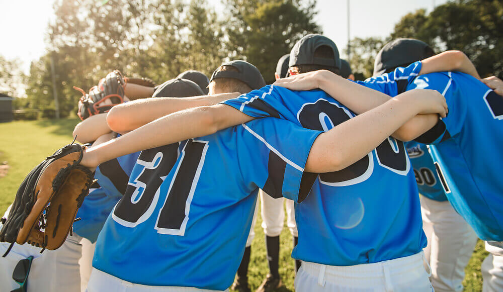 youth baseball team in huddle